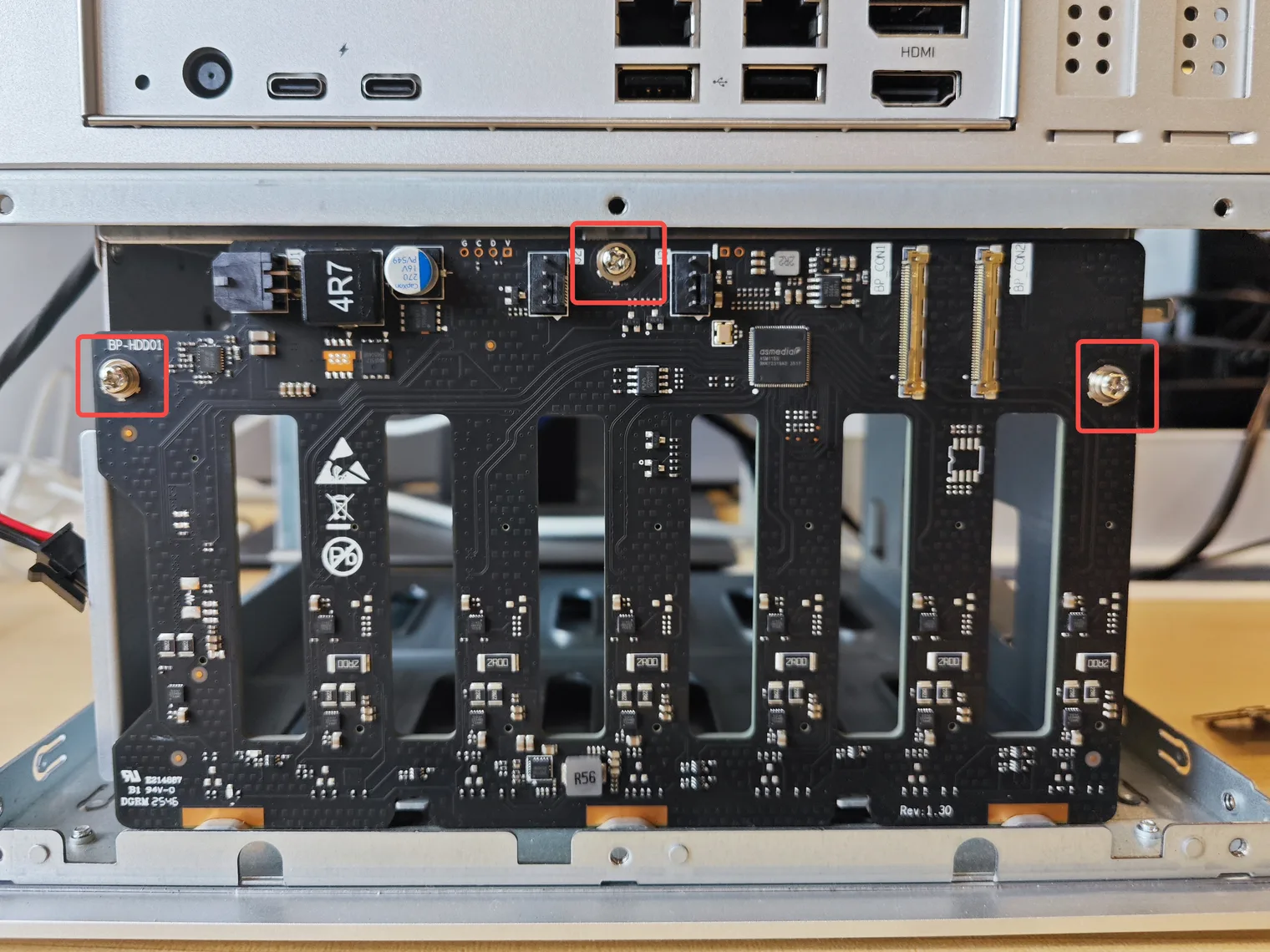 The three backplane screws marked with red boxes
